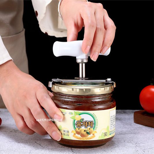 Stainless steel adjustable jar opener in use, effortlessly removing a sealed lid from a glass jar. Ideal for seniors and arthritis sufferers.