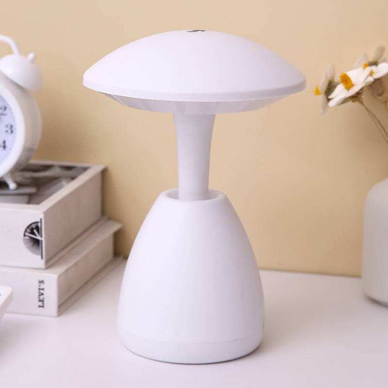 White bedroom eye protection small night lamp with a sleek mushroom-shaped design, placed on a desk for soft and stylish ambient lighting.